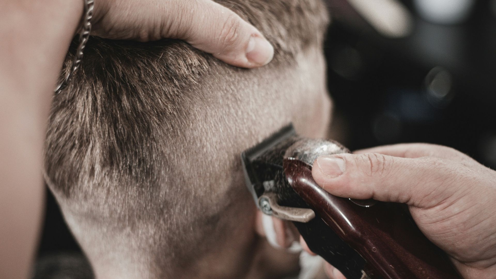 Close up of barber shaving head