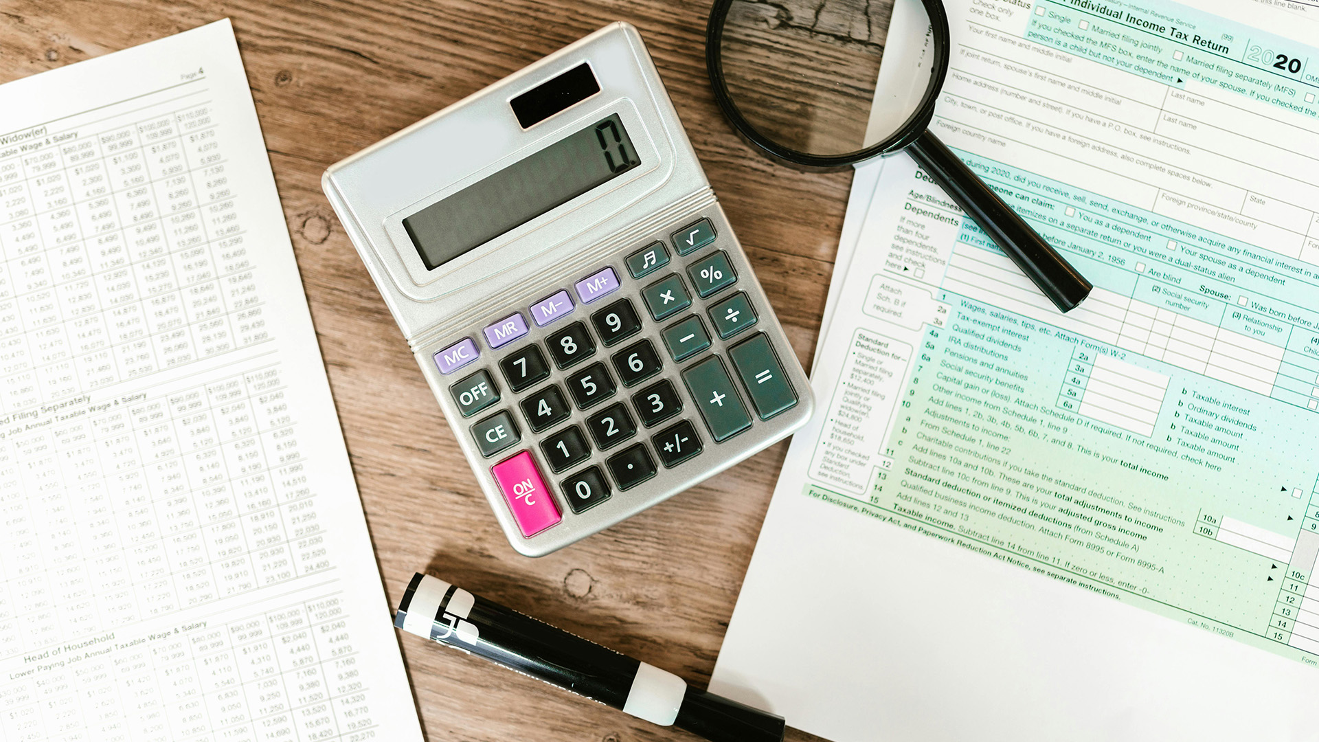 Calculator and workbook on desk