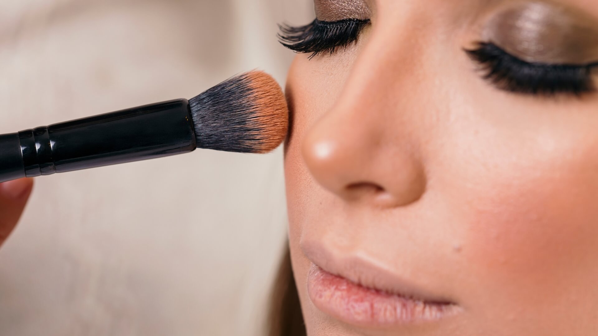 Founadtion brush being applied to a ladies face
