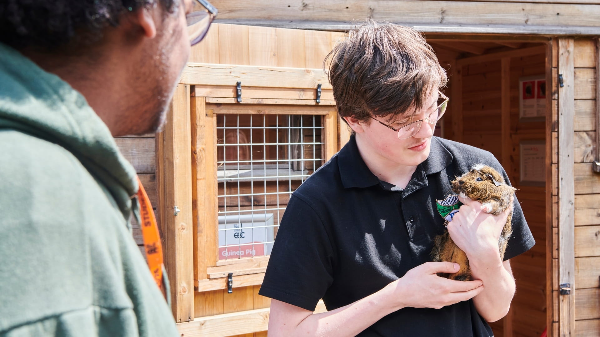 Student holding small guinea pig