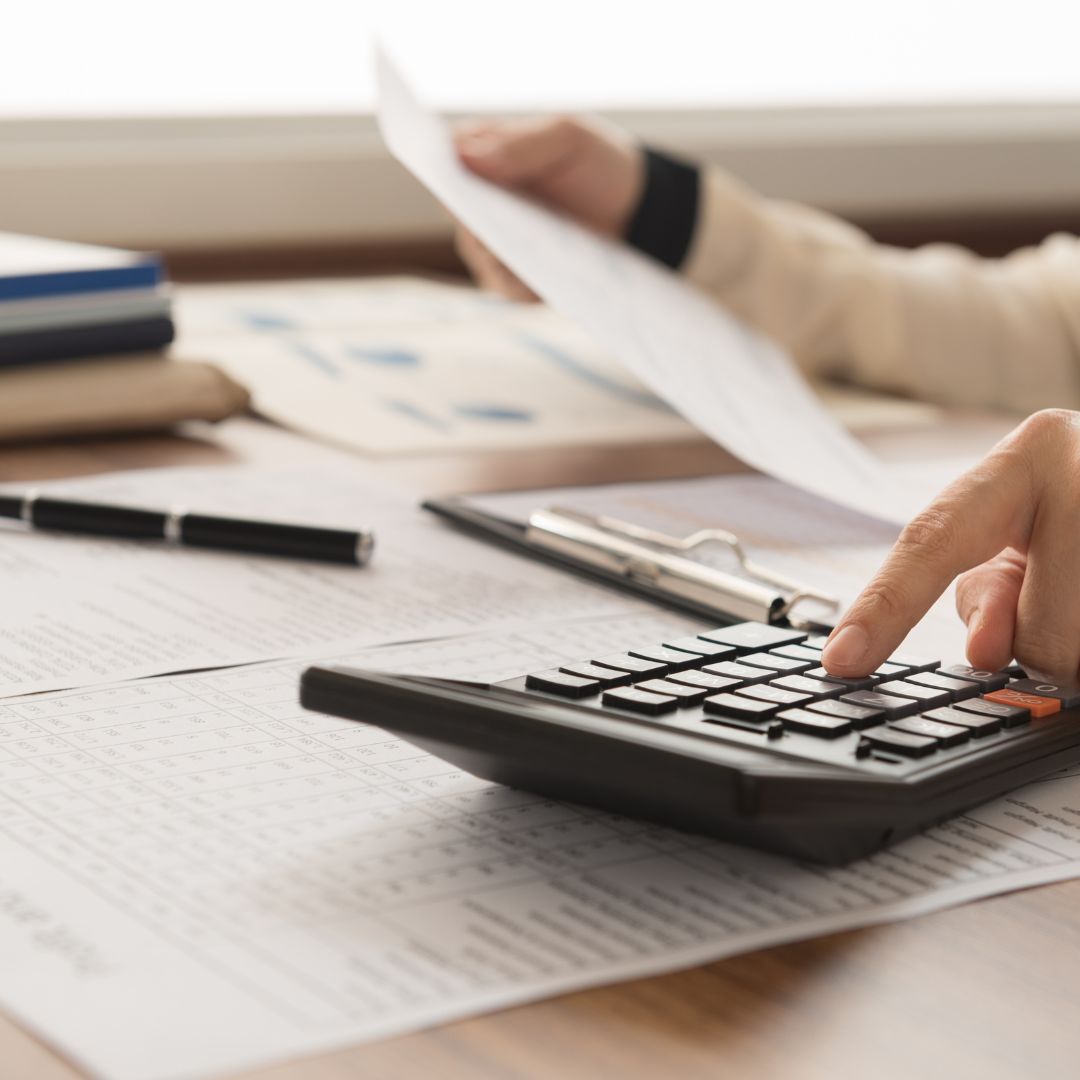 Calculator, worksheet of sums, and a ruler.