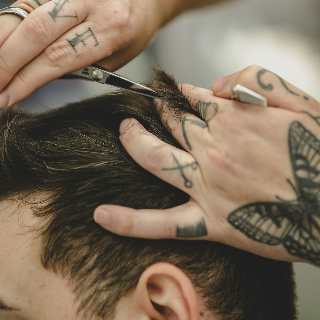 Close up of barber shaving head