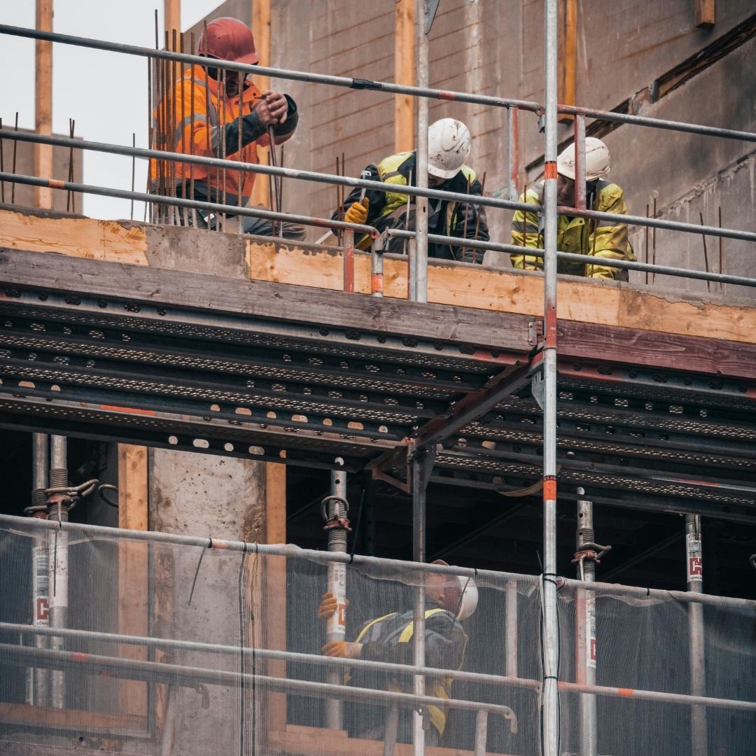 Group of people in hi-vis working on scaffolding