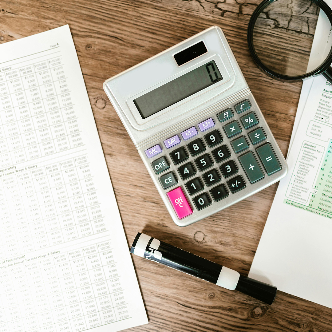 Calculator and workbook on desk