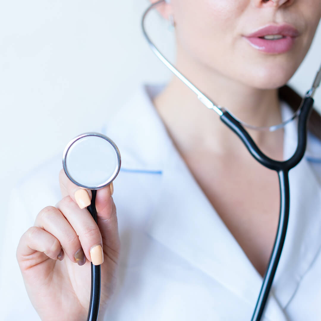 A woman wearing a whit lab coat and a stethoscope