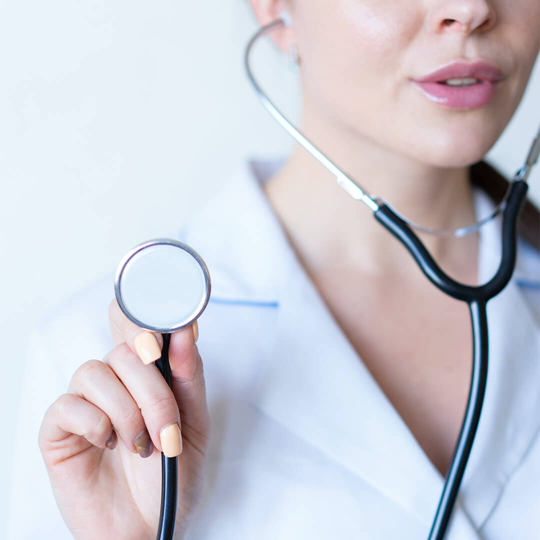 Doctor in white coat holding a stethoscope