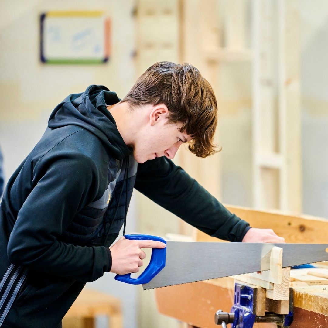 Two joinery students using a spirit level