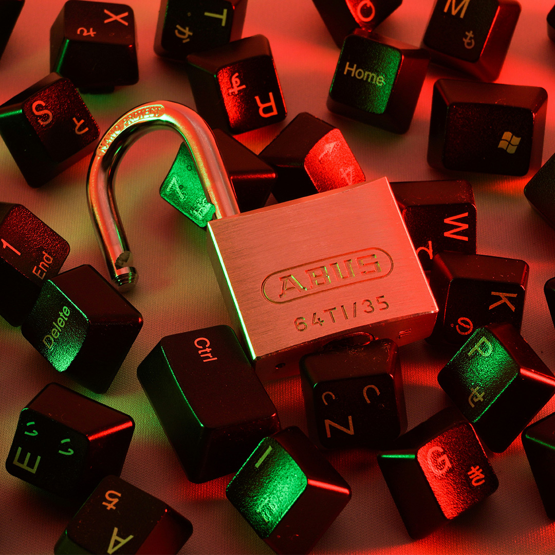Unlocked padlock surrounded by keyboard keys