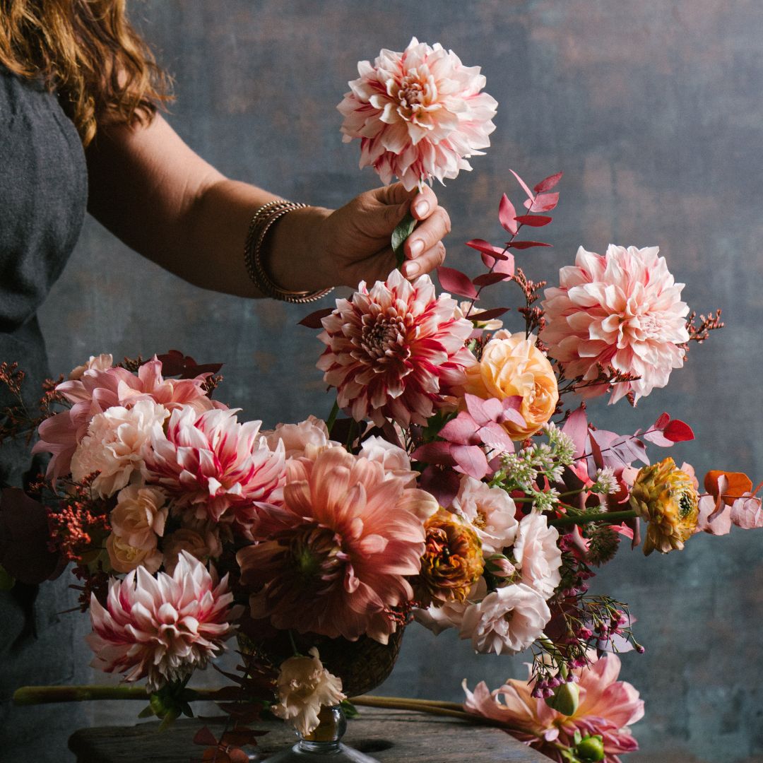 Women setting up a bouquet.
