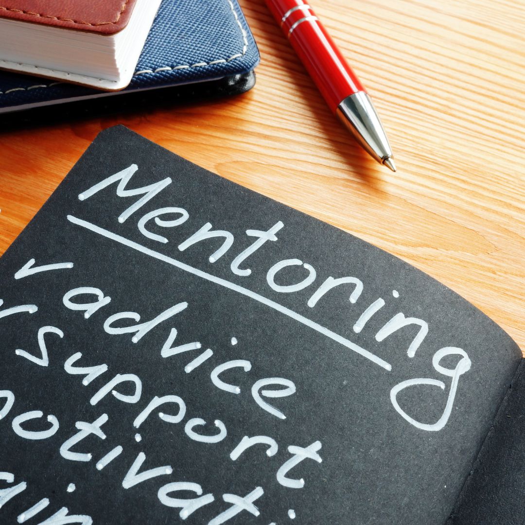 Book with mentoring written in white inside.