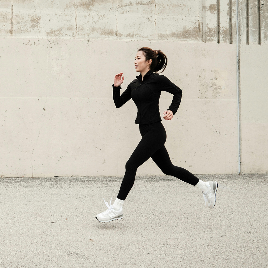 Young woman jogging on wooden boards