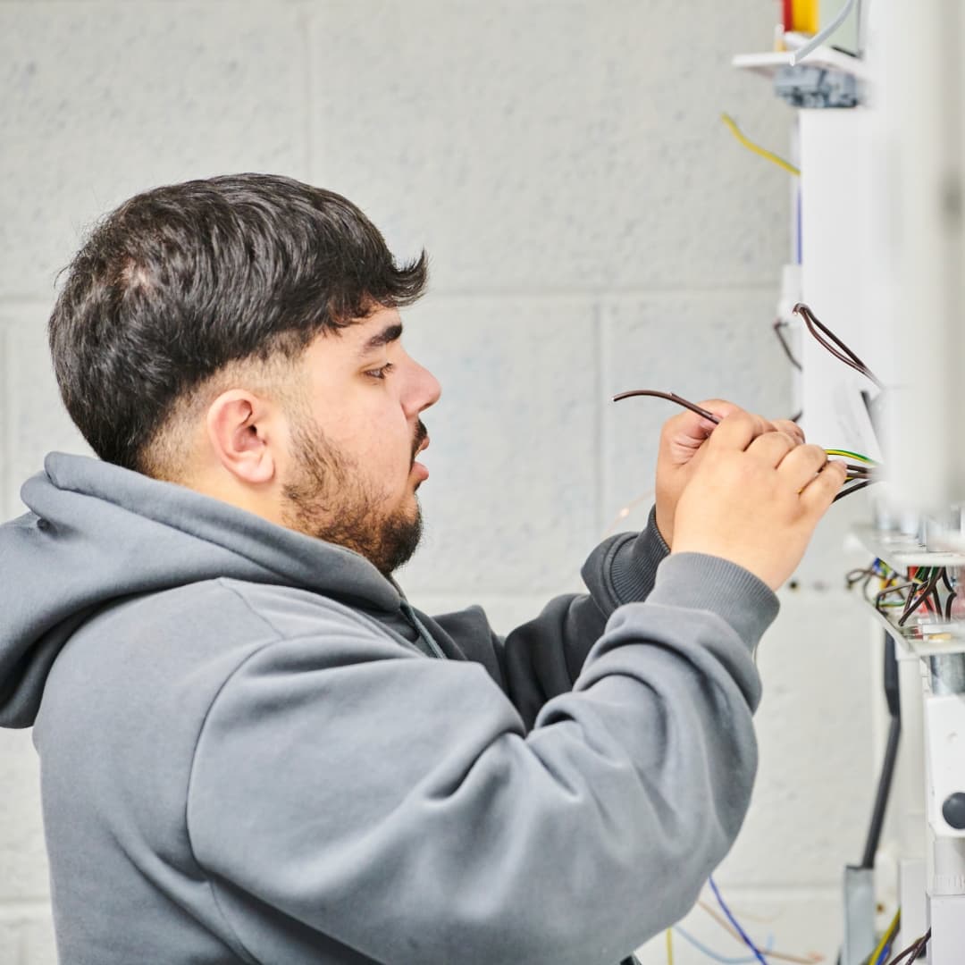 Electrical student inspecting wires