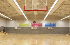 East Durham College sports hall with basketball nets visible and bleachers