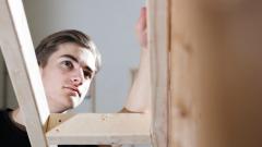 A joinery student putting wood together