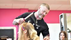 A man cutting a woman's hair