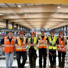 A line of students wearing hi vis and PPE smiling