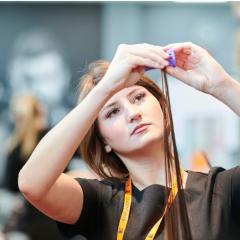 Student putting roller into hair