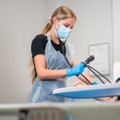 Healthcare student using equipment