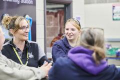 Student and teacher in workshop smiling at one another
