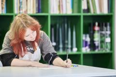 Student at desk writing