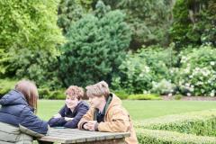 Group of students sat on picnic bench outside